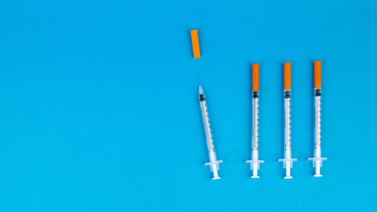 IVF needles on blue background