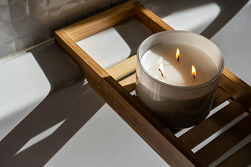 Candle on tray in bath
