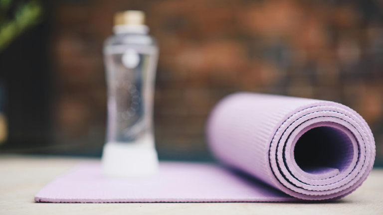 Purple yoga mat and water bottle