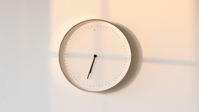 Clock on wall with shadows