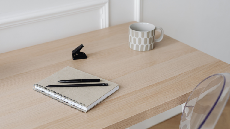 how to handle working mom guilt coffee and notebook on desk